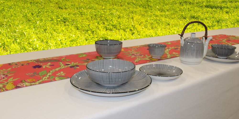 Table runner with tableware on table